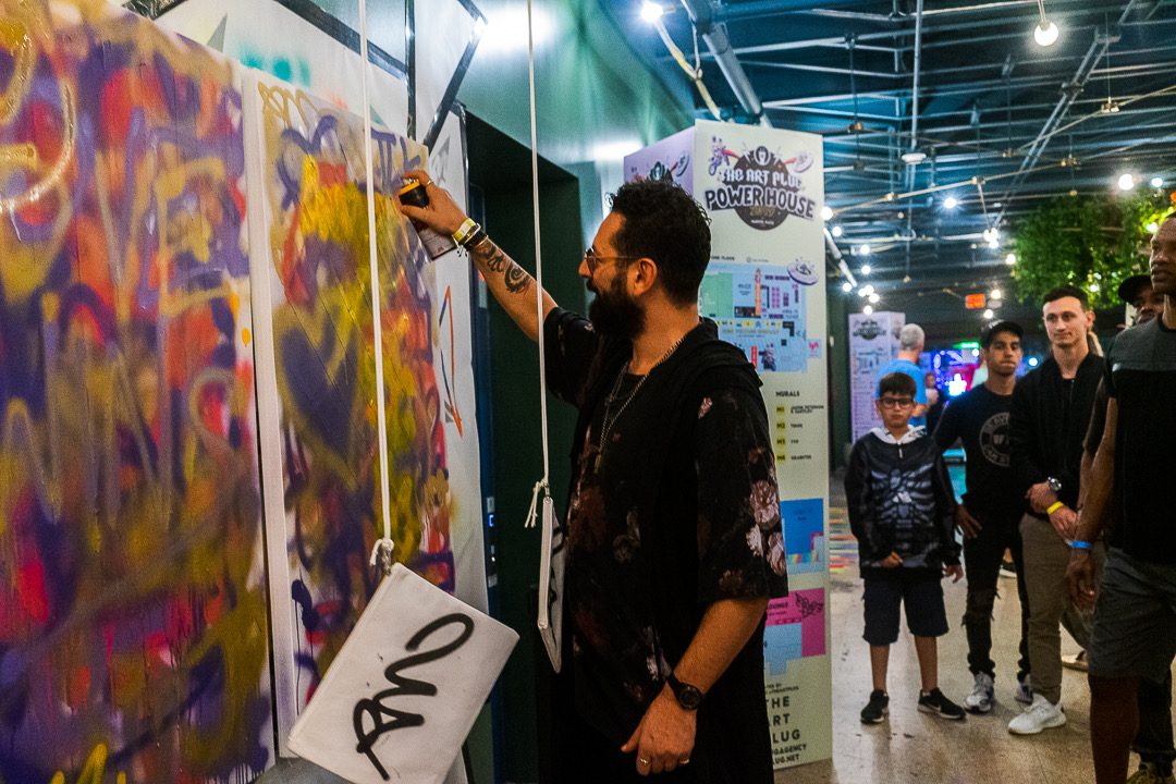 A guest adding their mark to the canvas