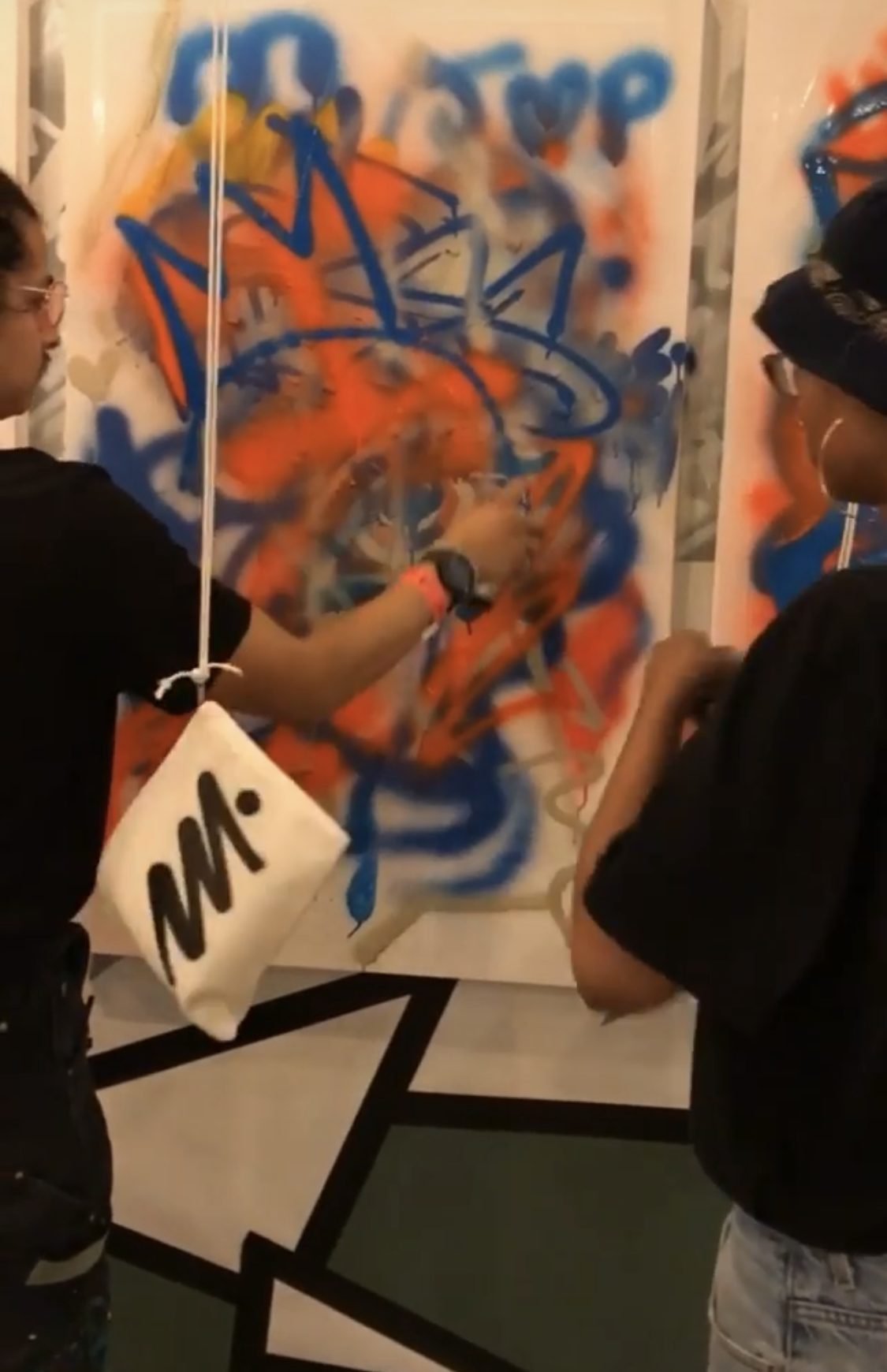 Guests spray-painting the canvas together
