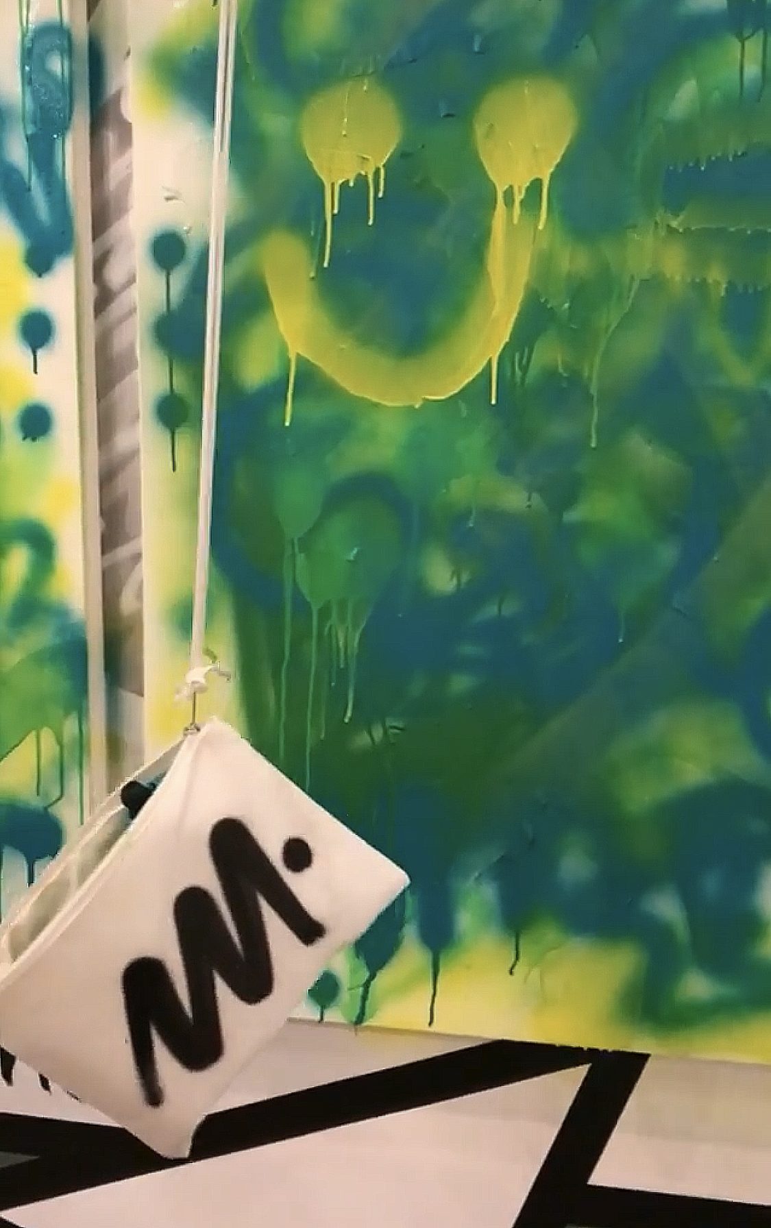 Guests spray-painting a canvas together at a Creating Art Together event